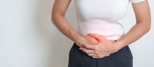 Woman holding her stomach area
