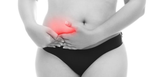 Woman holding stomach in pain