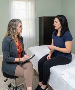 Patient during an initial pelvic floor physical therapy assessment with a provider at a pelvic health clinic in Bethesda, MD