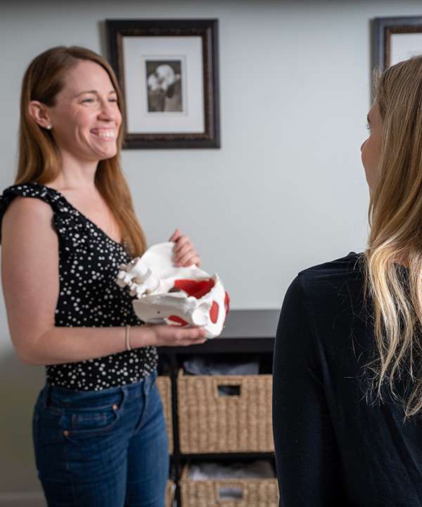 physical therapist guiding a patient through therapeutic exercise in a clinical setting